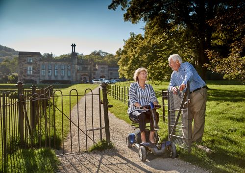 Autochair Lifestyle Photoshoot Couple On A Walk With Mobility Scooter