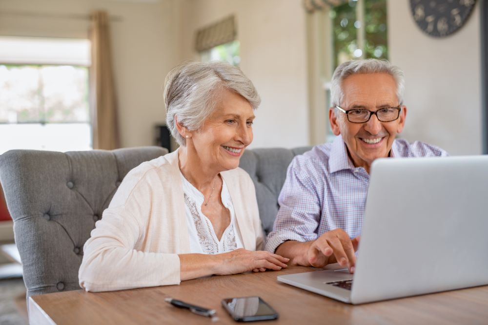 Autochair Virtual Assessment Elderly Couple Looking At A Laptop
